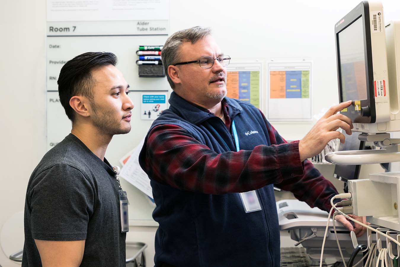 Seattle Children's nurses examine inforation on a screen. The Center for Pediatric Nursing Research advances clinical practice–focused research among Seattle Children’s nurses at all career levels.