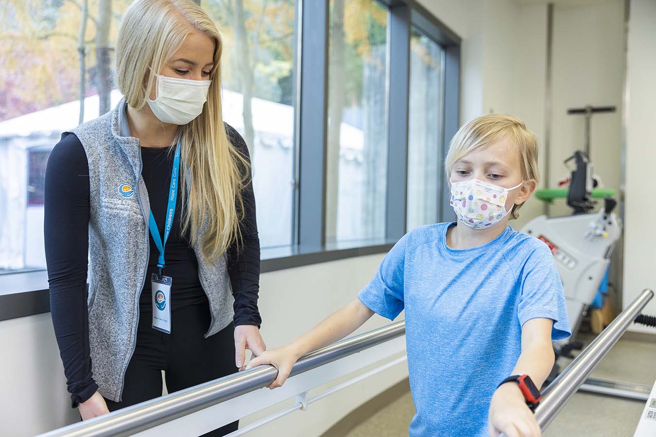 Hudson, Seattle Children's Heart Center patient, practices walking during a rehab session with Physical Therapist , Kaycee Howell. ​