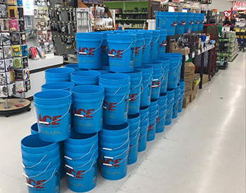 Blue buckets stacked at an Ace Hardware store