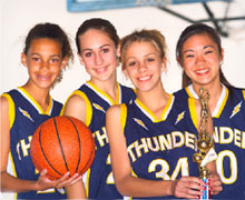 Girls basketball team with a trophy