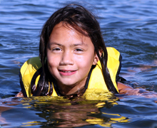 Girl in the water with a life jacket on