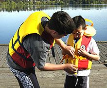 Parent helping child with life jacket
