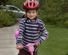 Girl on scooter with helmet