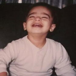 A young boy smiles at the camera