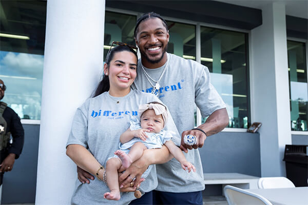 Mother and father holding a baby