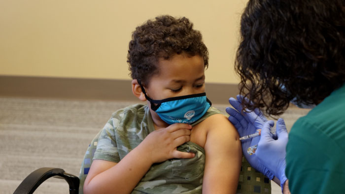 A boy receives a vaccination