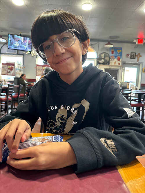 A boy sits at a table