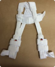 A Pavlik harness, made of flexible white straps, may be used to treat hip dysplasia in young babies.