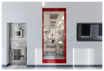 A wall with a glass door looking into a gmp lab