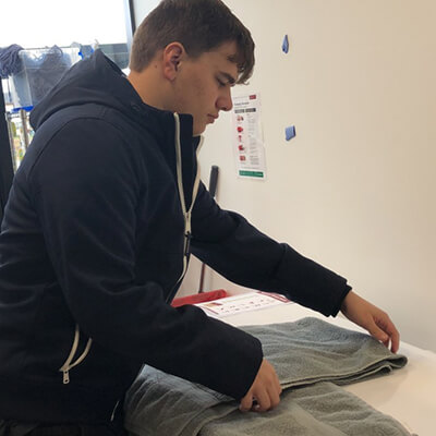 A man folding towels