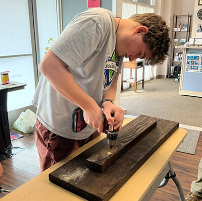 A man working on wood with a power tool