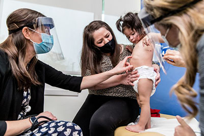 A Seattle Children's doctor examines a baby