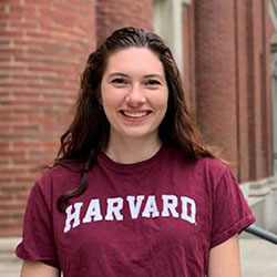 A young woman in a Harvard shirt