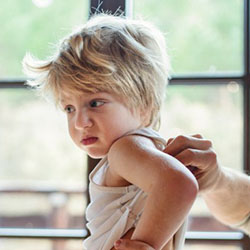 Father looks looks at his young son's back