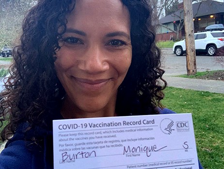 Dr. Monique Burton shows her COVID-19 Vaccination Record Card
