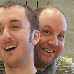 father and son smile in a very close selfie
