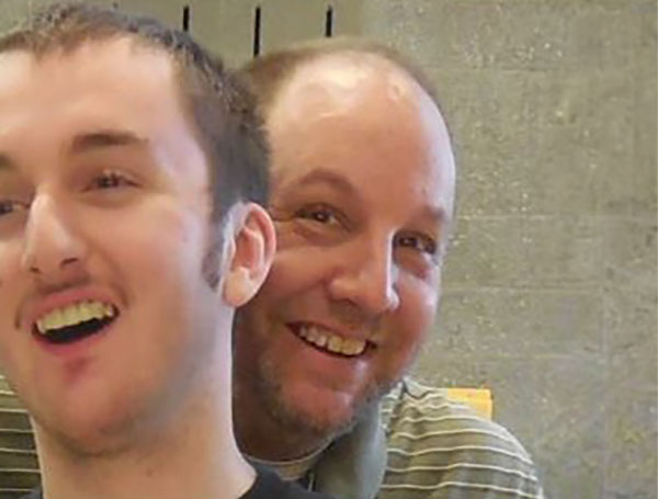 father and son smile in a very close selfie