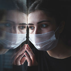 A patient contemplates their future while staring out of a window. 
