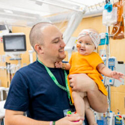 A father holds his daughter in a hospital