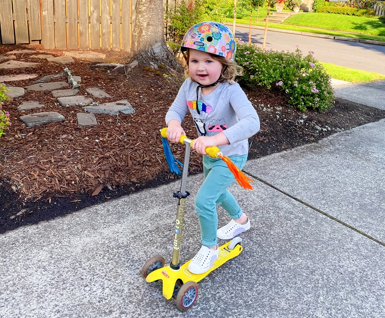 little girl riding a scooter