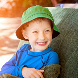 Child drying off in the shade during summer.