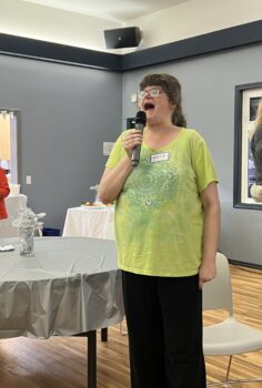 a woman standing with a microphone