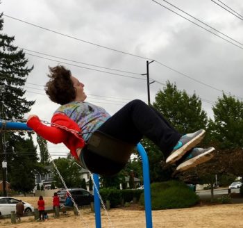 A woman swings at the park