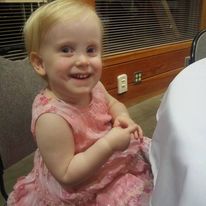 A toddler in a pink dress