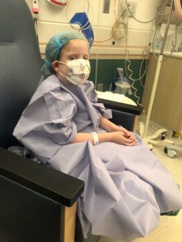 A girl in a hospital gown