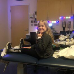 A girl sitting on a hospital bed