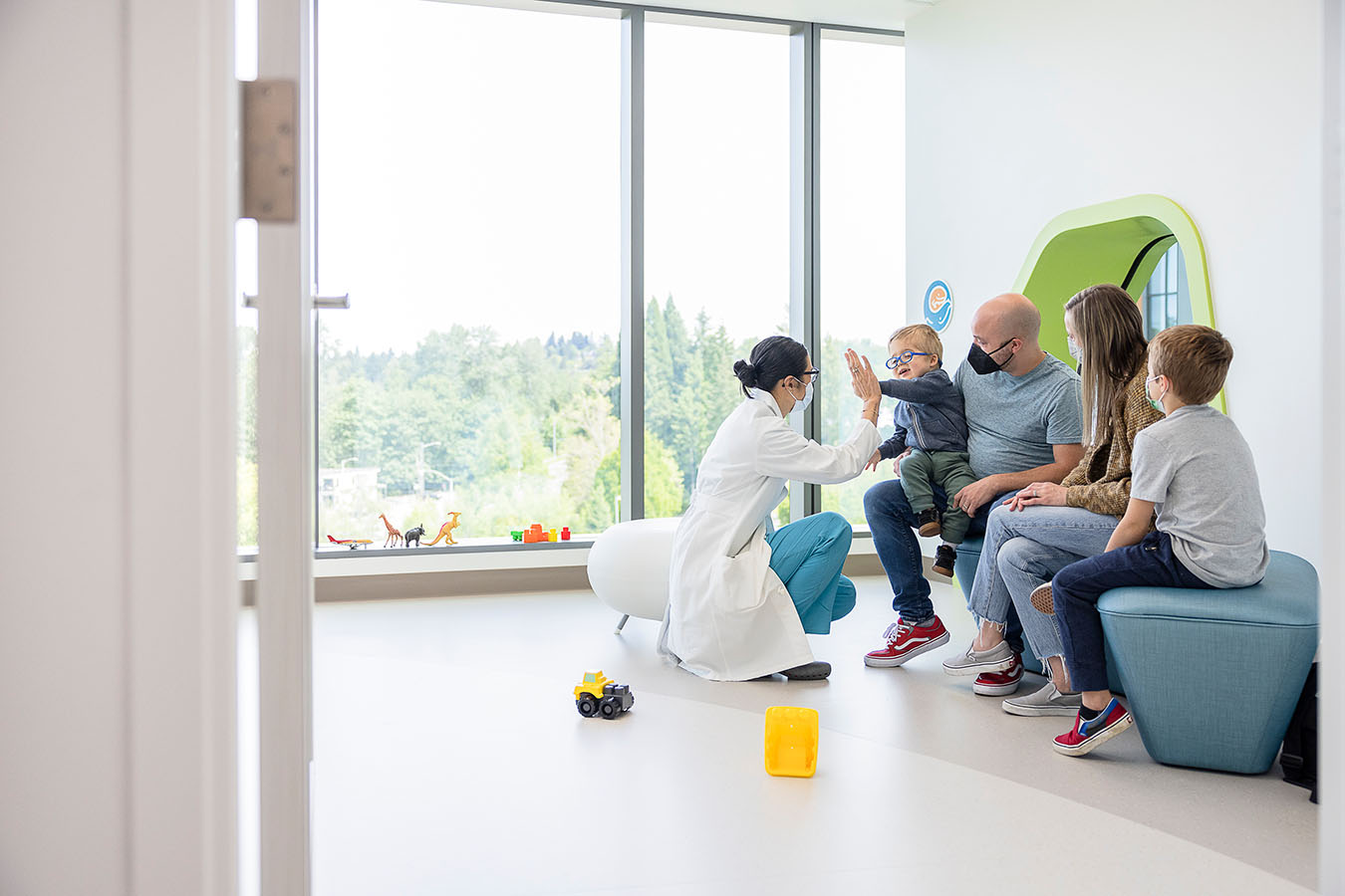 A family speaks to a doctor in Forest B's family area.