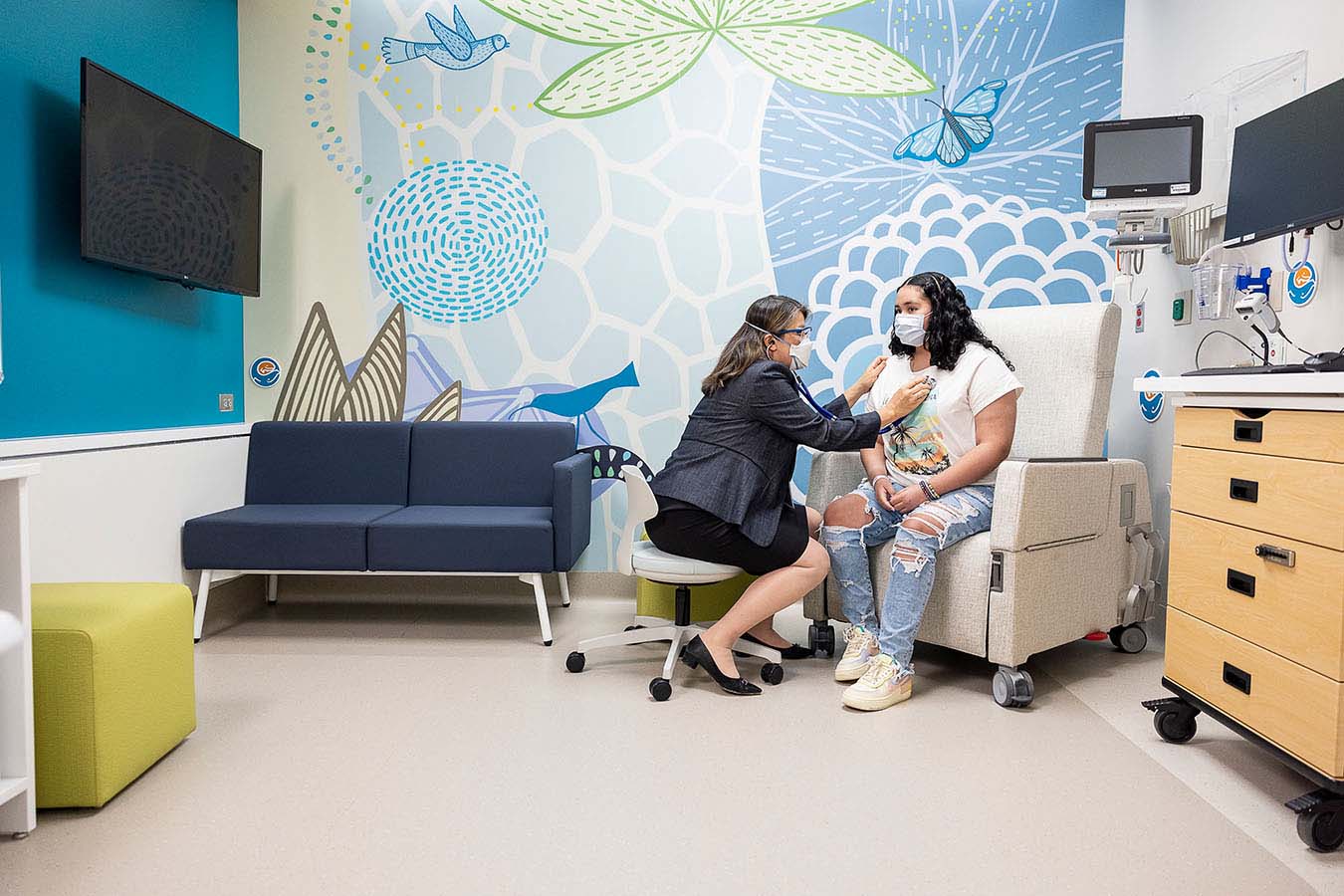 A patient speaks with a doctor in a universal room of Seattle Children's Forest B.