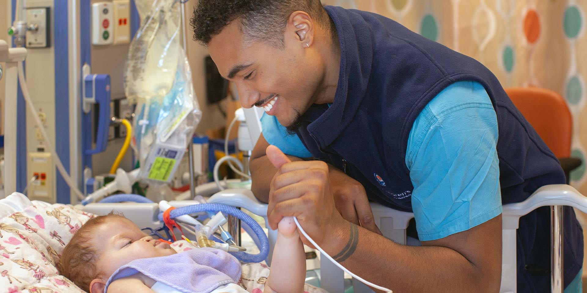 A nurse checks on a baby at Seattle Children's