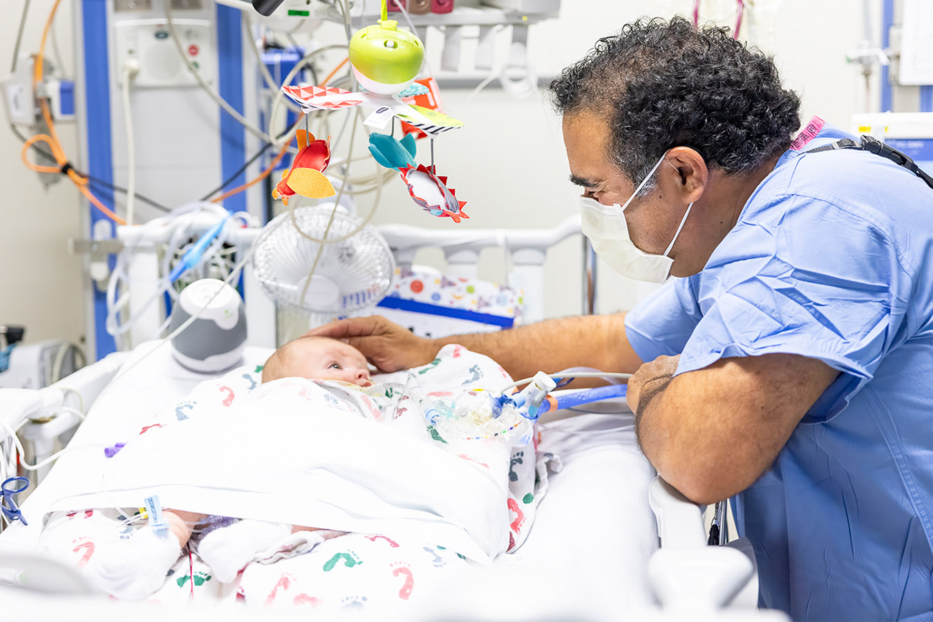 Provider attending a baby in a hospital bed