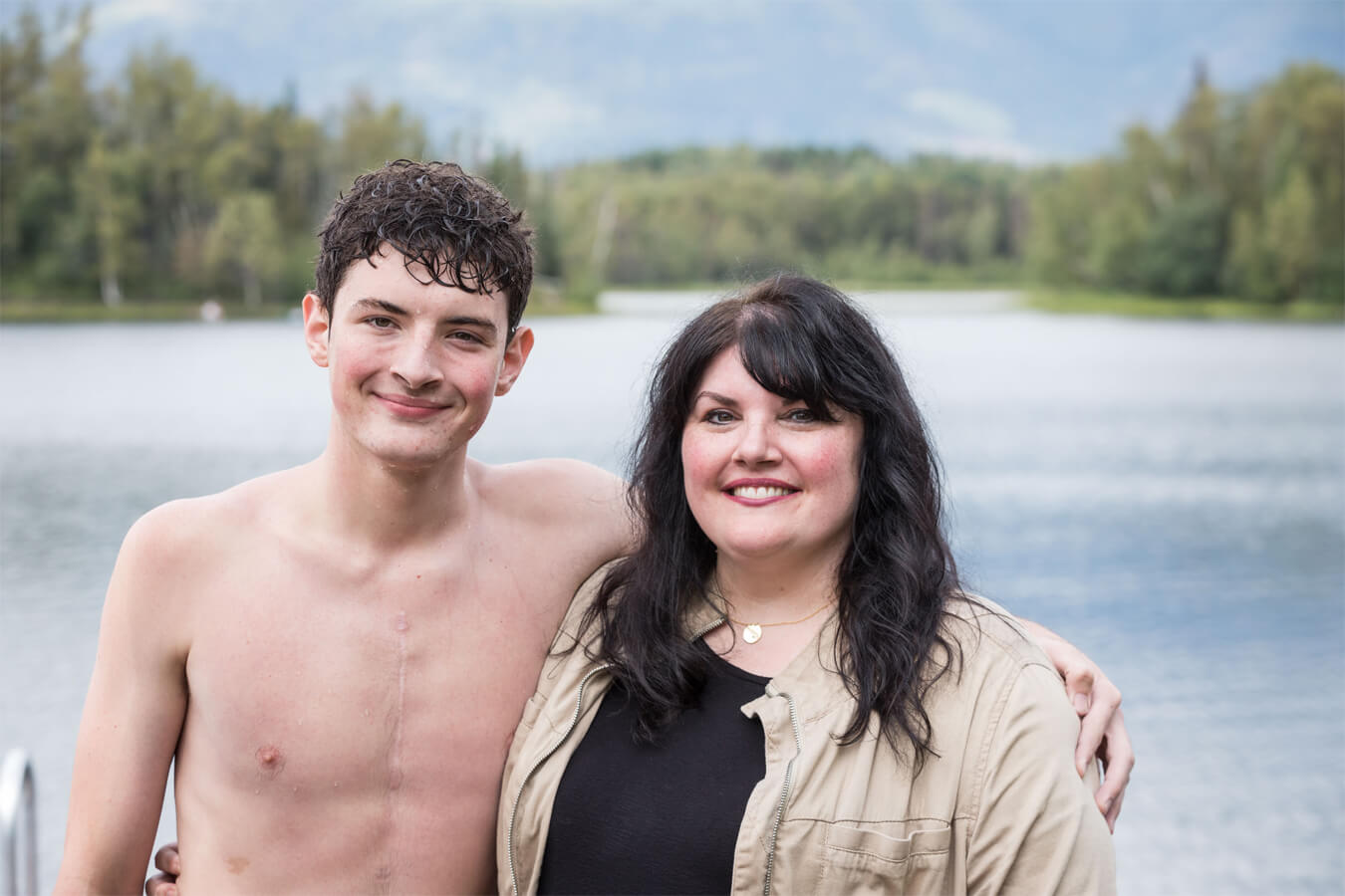 Heart patient and mother in front of a lake