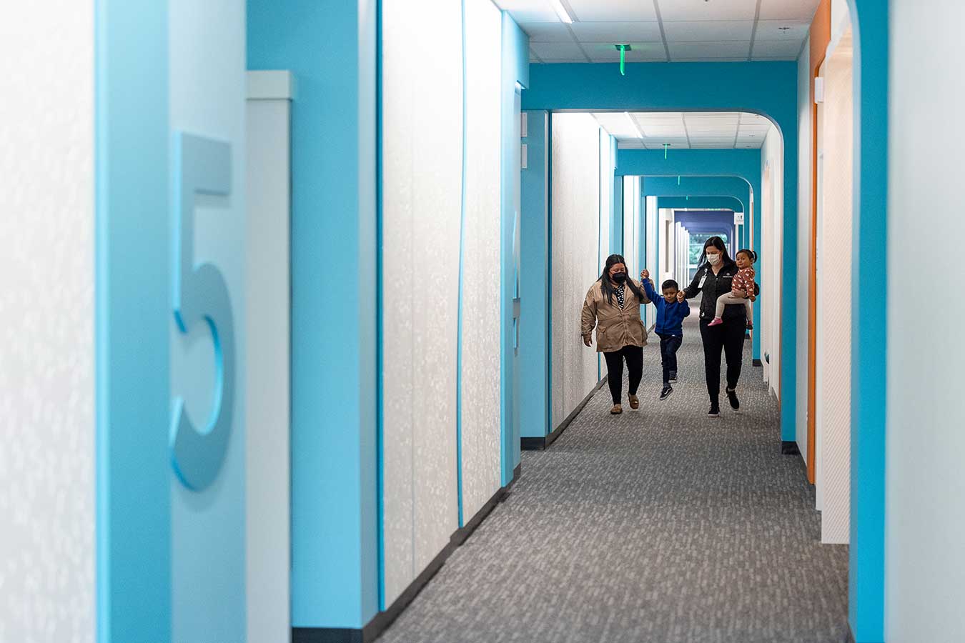 A family walks down a hallway in Seattle Children's Magnuson Clinic