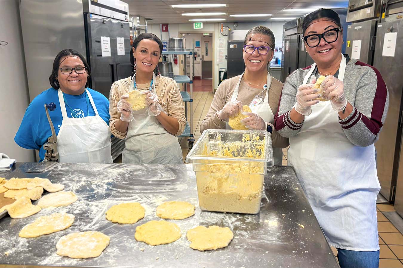 Women in a kitchen working with dough