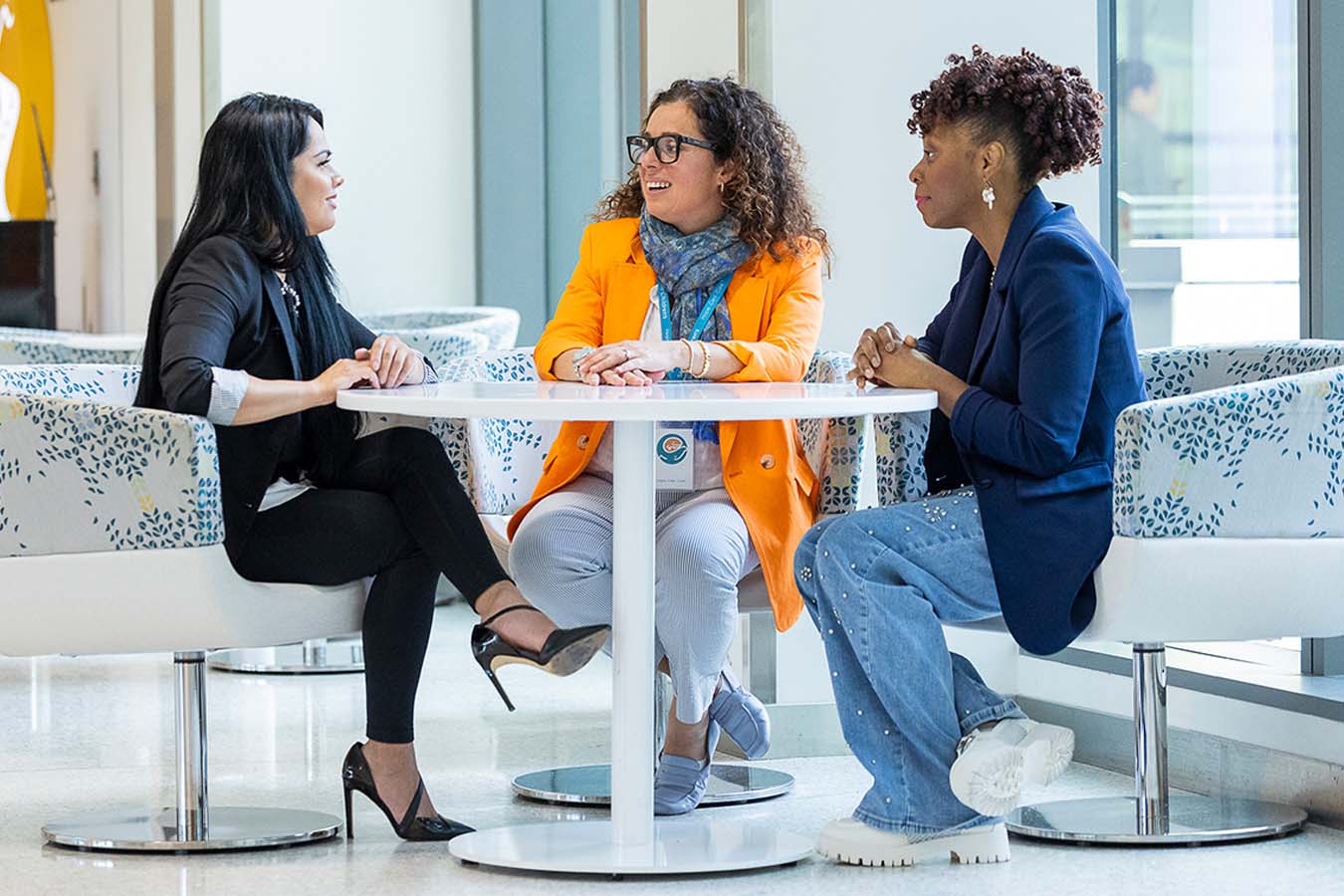 3 women at a table talking