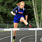 A girl jumps over hurdles