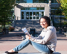 Mariah McHenry A girl sitting in front of a building