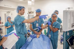 Dr. Kaalan Johnson leads his team through a surgical simulation
