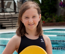 Katie Belle 220x180 A girl in front of a swimming pool