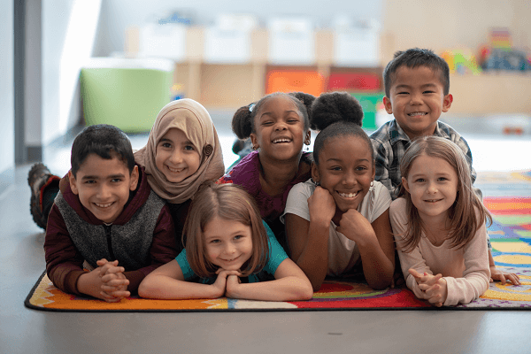 Smiling group of children on mat
