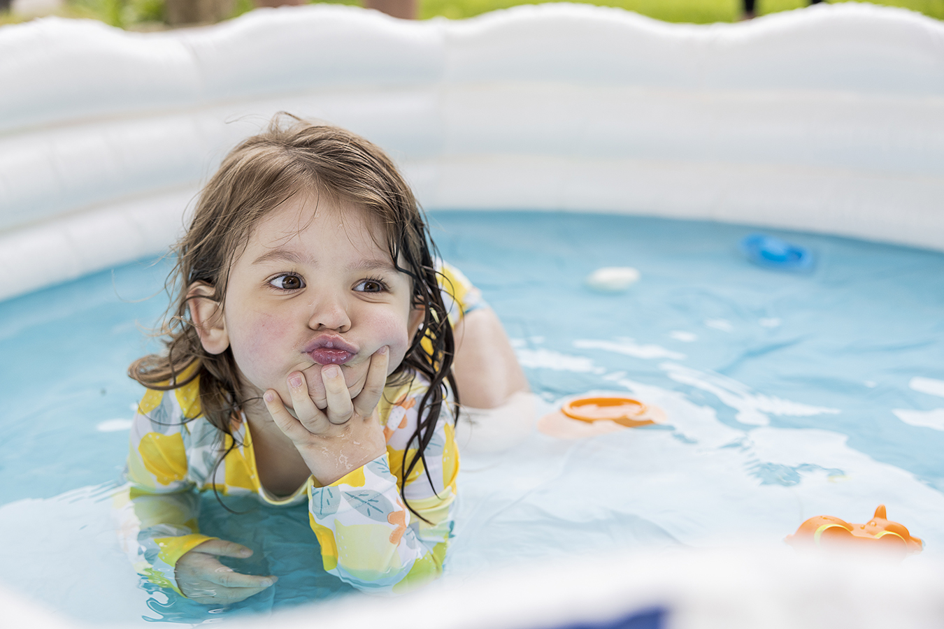 A girl plays in a pool.