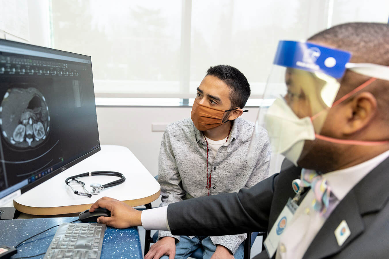 Dr. Dick with patient reviewing and explaining scans