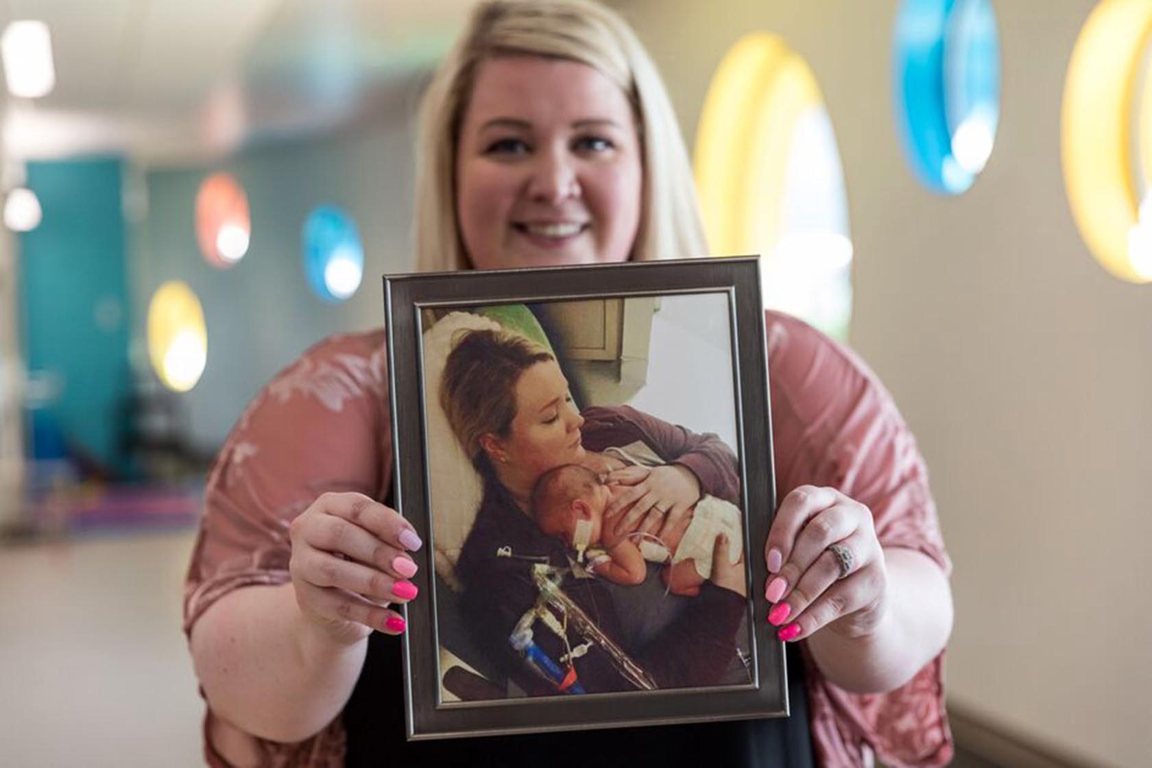 Cassie Fannin, mother of a patient treated for a CDH at Seattle Children's, holds a photo