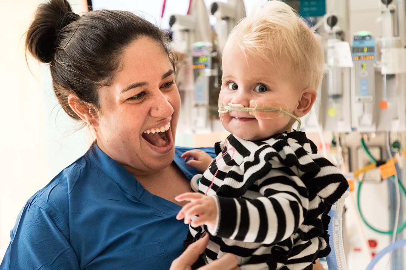 A Seattle Children's nurse holds a child. Seattle Children's benefits package for nurses demonstrates our commitment to supporting your health and well-being.