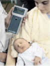Evoked Otoacoustic Emissions (EOAE) test being performed on newborn