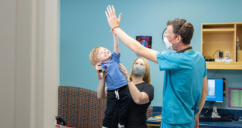 a doctor high fiving a patient