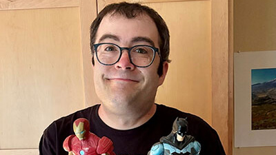 A man standing outside by a sign that says Seattle Children’s Alyssa Burnett Adult Life Center